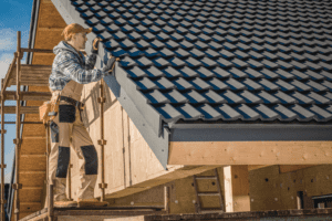 A man checks the roof of a house