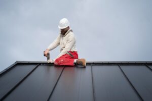 Image of a roofer inspecting a roof for any potential problems