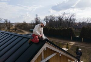 An expert roofer surveying a roof for signs of damage
