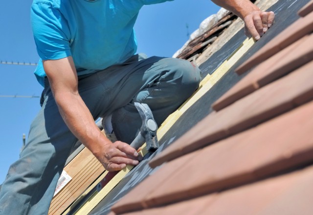 Shingles being removed from a roof