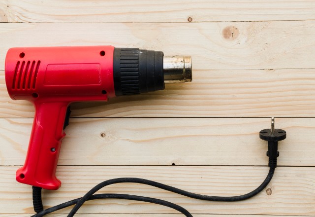 Use a Heat Gun to Remove Loose Paint or Old Caulk Around the Seams