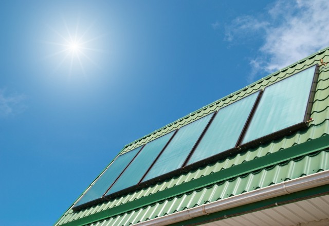 Green metal roofing with solar panels