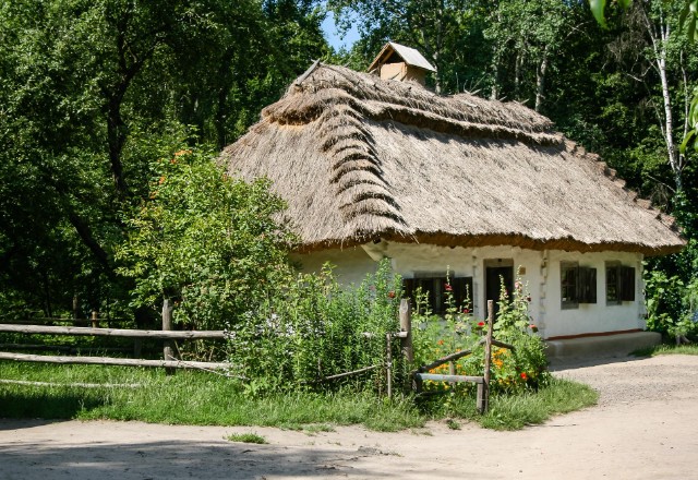 Picture of a traditional thatched-roof house, showcasing its timeless charm and appeal.
