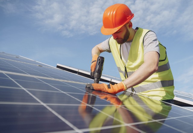 Solar installers using specialized tools and equipment for a secure installation process.