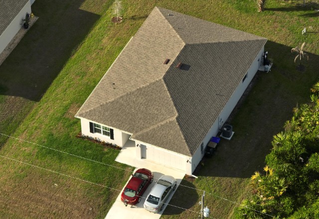 A picture of a house with an asphalt shingle roof - Asphalt shingle roofs are durable
and can last up to 30 years when maintained properly.