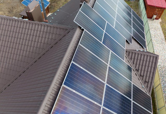 A professional installer attaching solar panels to the roof of a home.
2. An array of solar panels producing clean, renewable energy.