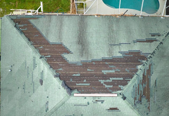 An image of loose or missing shingles - Loose or missing shingles are signs that
replacement may be necessary, so addressing them promptly is essential for maintaining
a healthy roof over time.