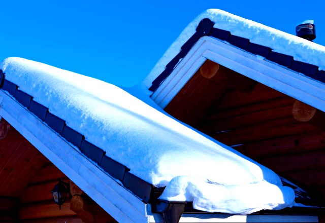 A thick layer of snow on the roof - time to seek professional snow removal assistance