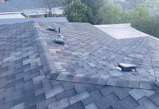Well-maintained roof with grey shingles and vent pipes, showcasing quality roof repair services in Spokane Valley.