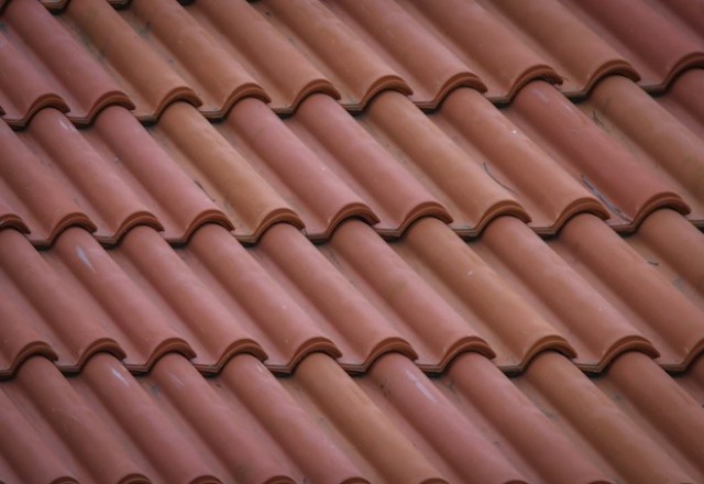Close-up of a terracotta tile roofing installation in Spokane, showing the uniform rows of curved tiles creating a textured pattern