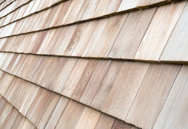 Cedar wood shingles for siding, featuring natural color variations and textures, available for installation by Spokane siding contractors.