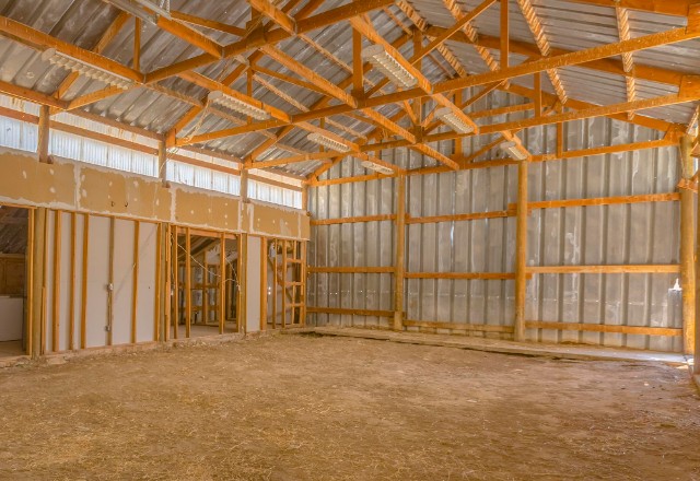 A pole barn is prepared for insulation installation