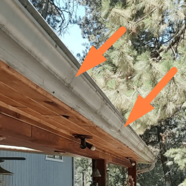A wooden eave with a gutter system showing signs of wear and possible leakage points, a task for Spokane gutter maintenance specialists.
